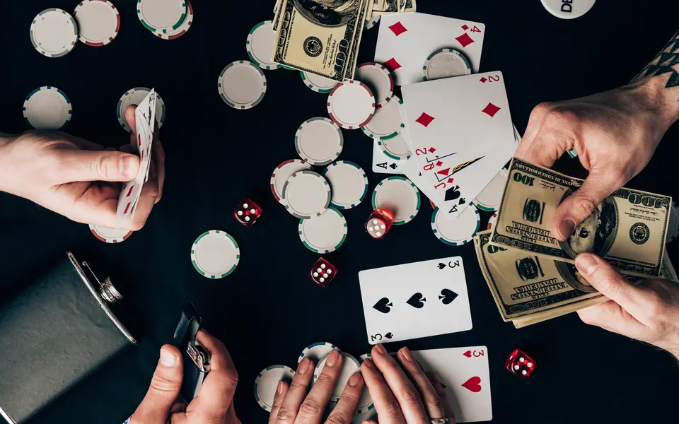 Overhead view of hands playing poker, illustrating PPPoker clubs in the Philippines